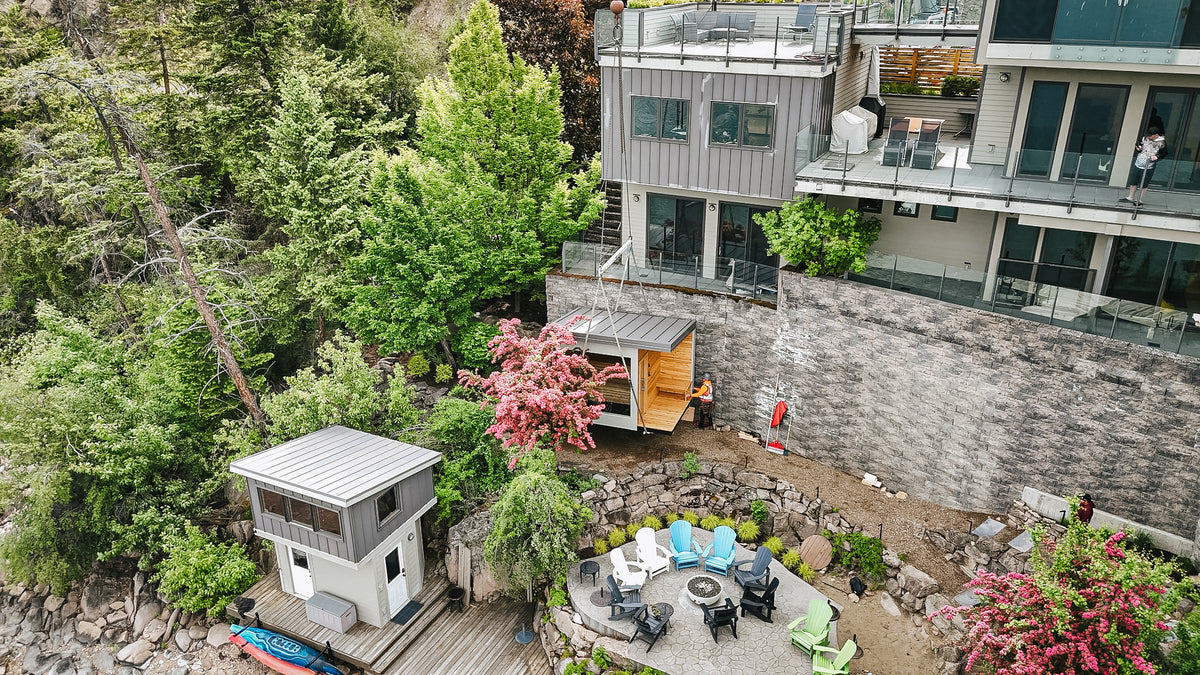 Drone view of a Mode Sauna installed on the terrace below a modern lakefront home