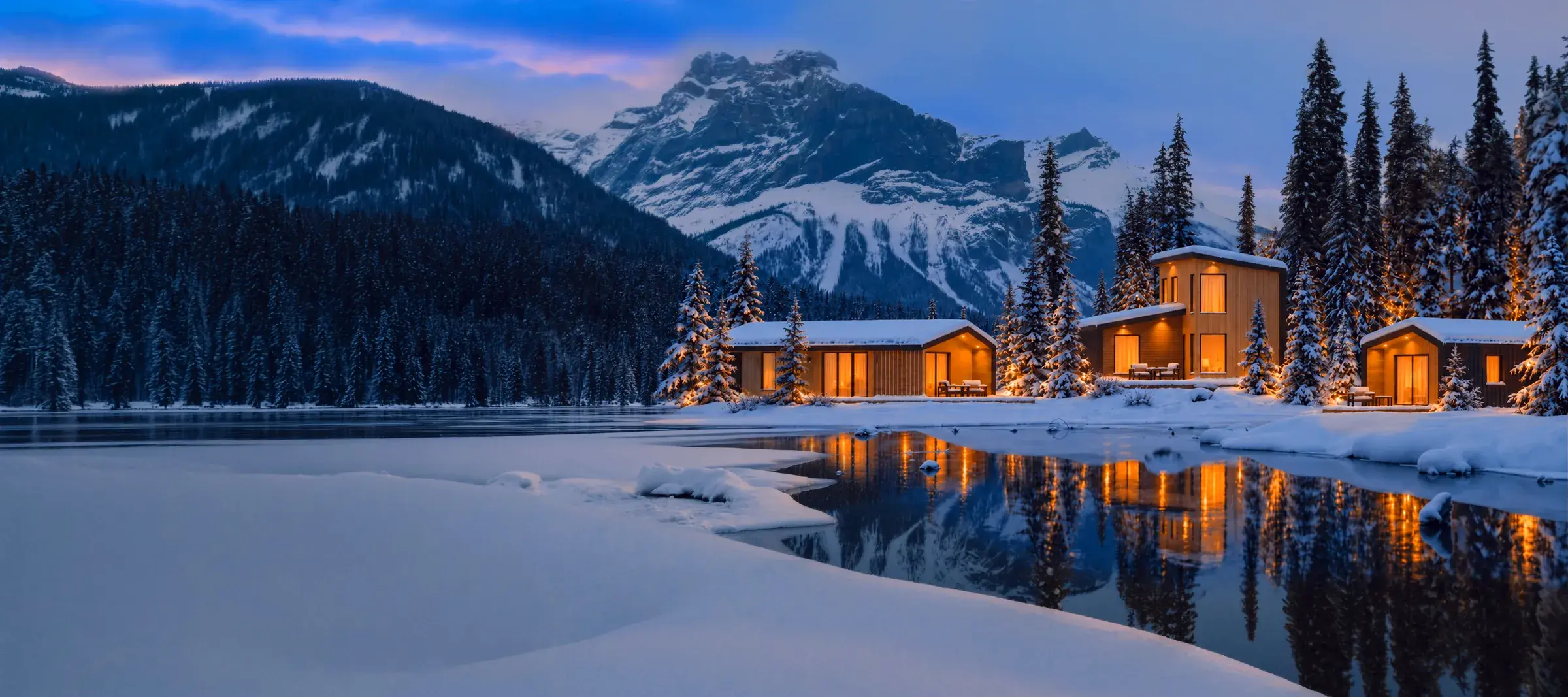 Cabins beside a winter lake at dusk
